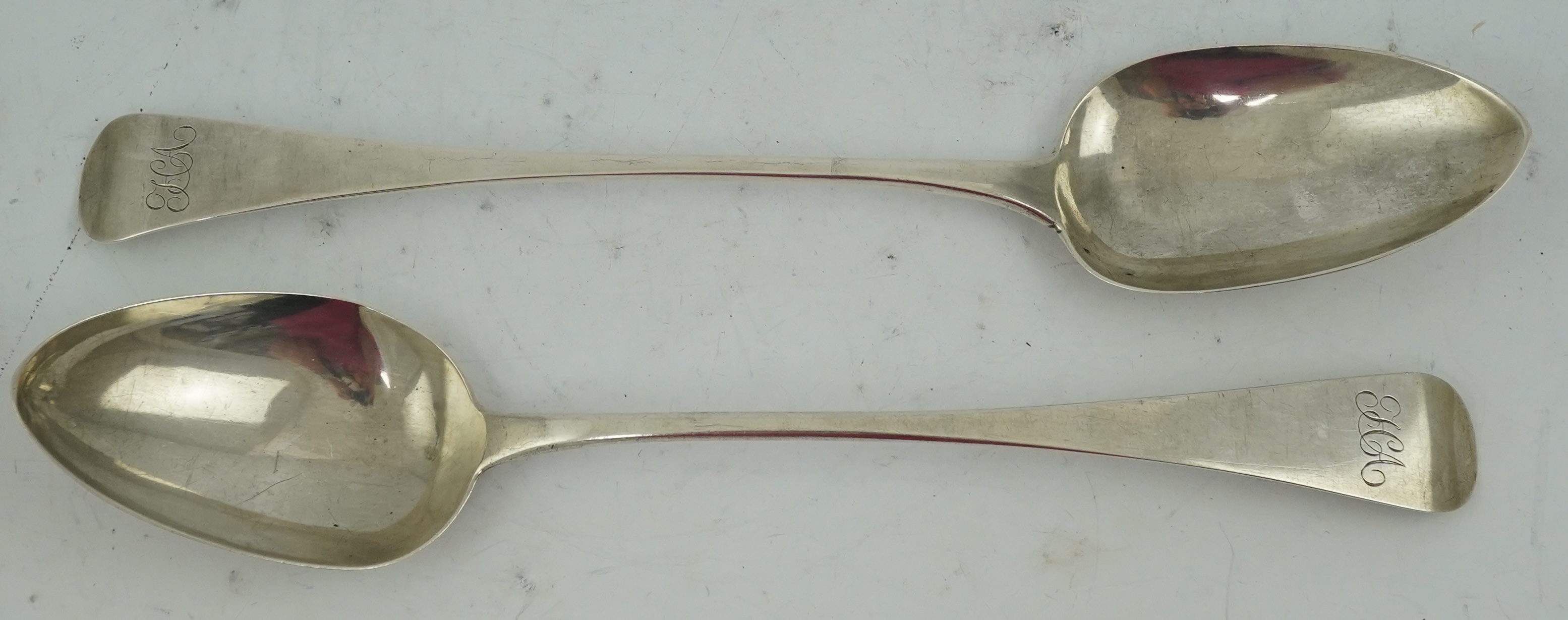 A George III provincial silver Old English pattern basting spoon by George Murray, Newcastle, 1824, 30.3cm, together with a similar George IV provincial silver basting spoon, by Barber, Cattle & North, York, 1827, 29cm